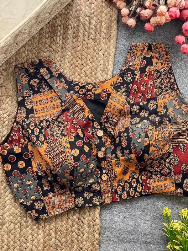 This_is_a_pure_Ajrakh_cotton,_handloom,_boat_neck_blouse_with_a_front_hook_closure_and_a_multicolor_patchwork_print.