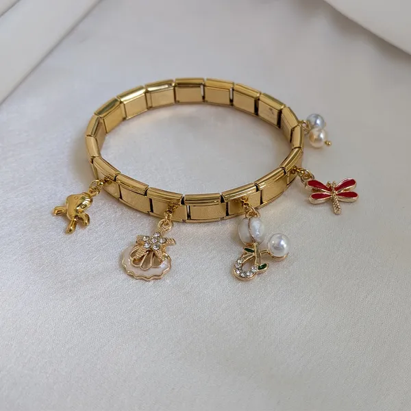 Playful_Gold_Plated_Charm_Bracelet_with_Pearl,_Dragonfly_&_Bow_Charms_Accents
