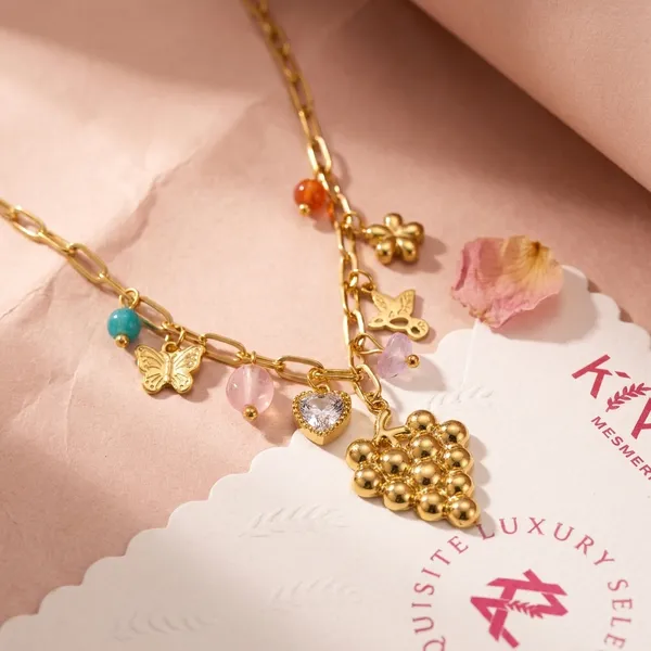 Luxury_Gold_Tone_Charm_Necklace_With_Colorful_Gemstone_Accents_And_Grape_Pendant