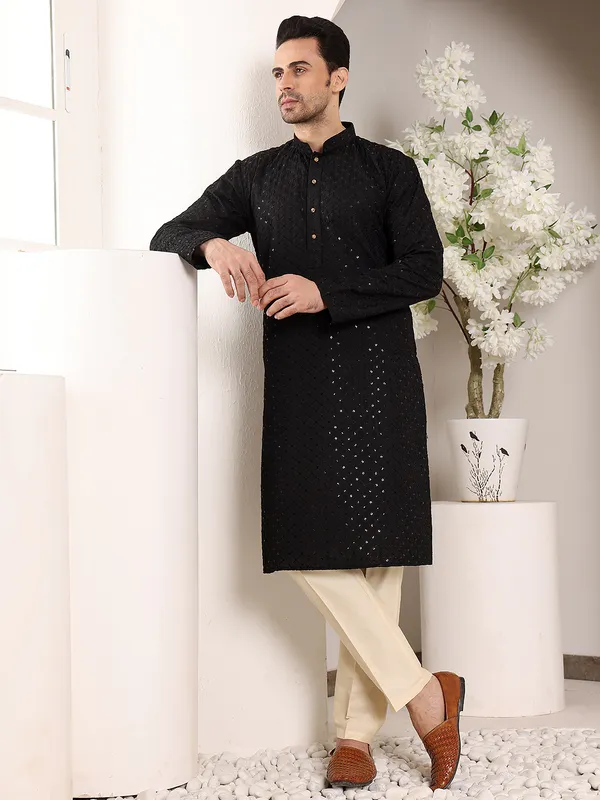 Men's_Black_Straight_Viscose_Silk_Kurta_with_Embroidered_Neckline_and_Motifs_and_Ivory_solid_trouser_style_churidar,_has_an_elasticated_waistband
