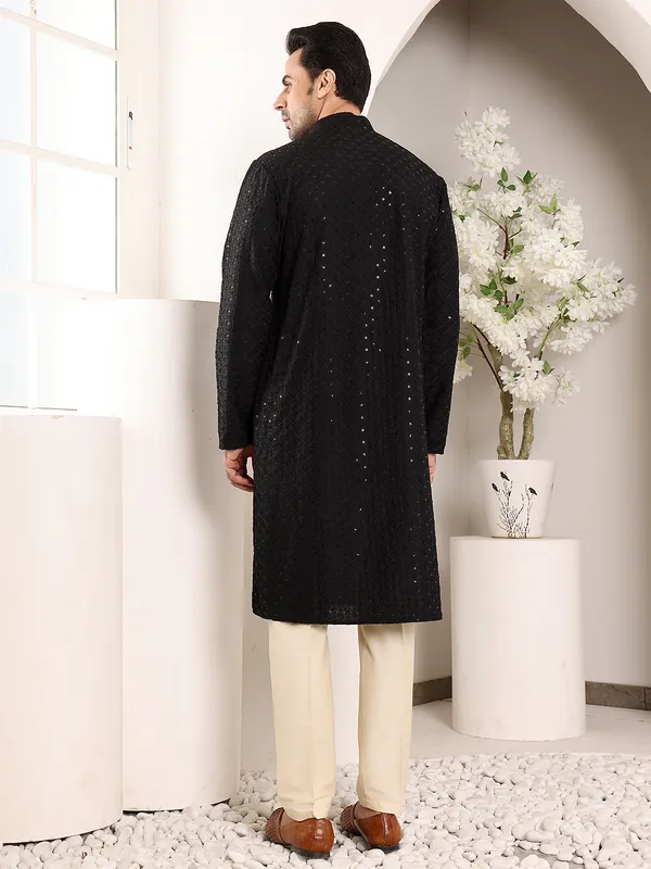 Men's_Black_Straight_Viscose_Silk_Kurta_with_Embroidered_Neckline_and_Motifs_and_Ivory_solid_trouser_style_churidar,_has_an_elasticated_waistband