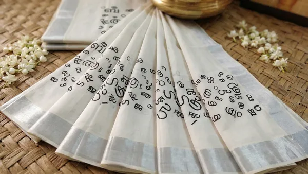 Off_White_And_Ivory_With_Silver_Border_&_Black_Script_Motifs_Akshara_Kasavu_Silver_Script_Motif_Kerala_Saree
