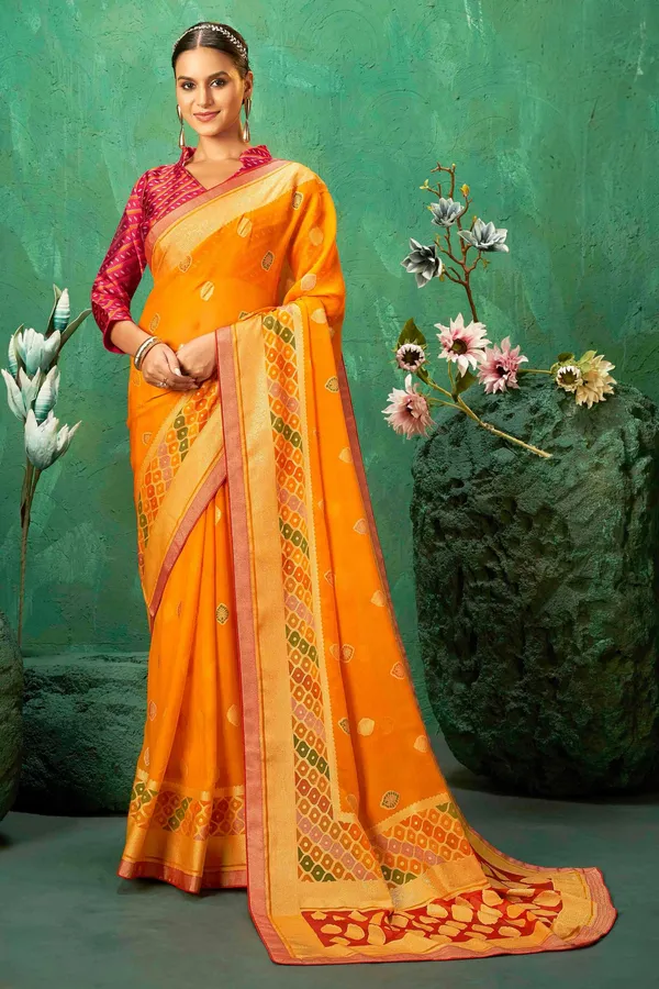 Orange_Exclusive_Brasso_Fabric_With_Vibrant_Color_Designed_With_Delicate_Self_Motifs_&_A_Luxurious_Contrasting_Border_Perfect_For_Festive_Events,_Weddings,_&_Bright_Celebrations.