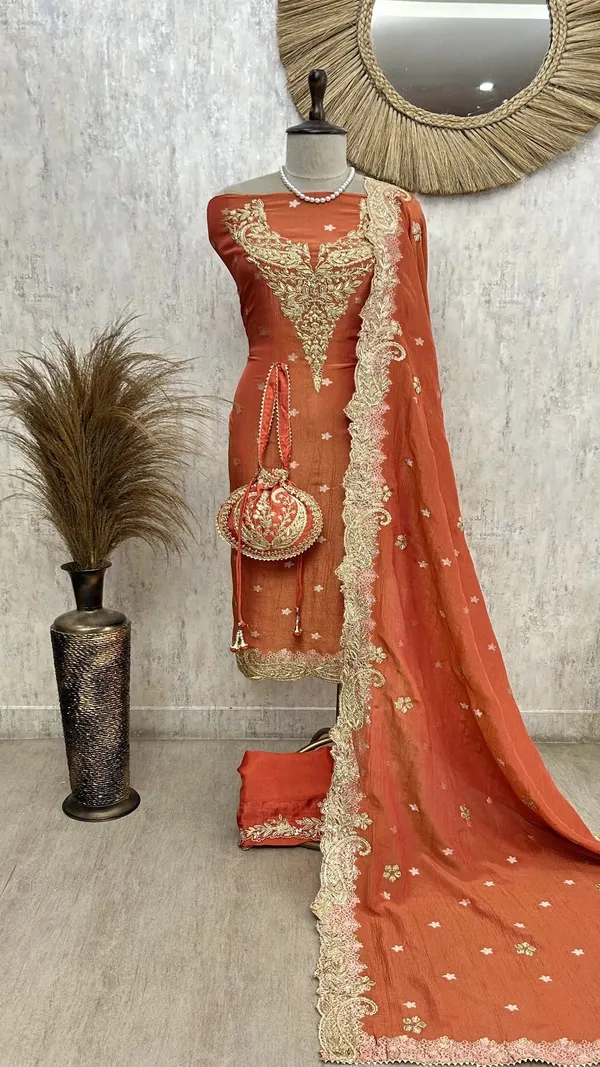 Zari_E_Gul_Tissue_Unstitched_Suit_With_Potli_Rust_Orange_With_Golden_Embroidery