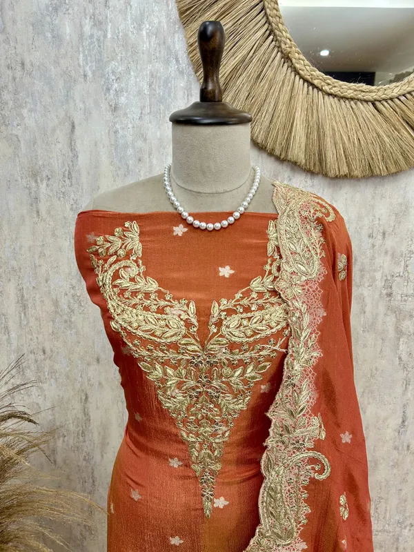 Zari_E_Gul_Tissue_Unstitched_Suit_With_Potli_Rust_Orange_With_Golden_Embroidery