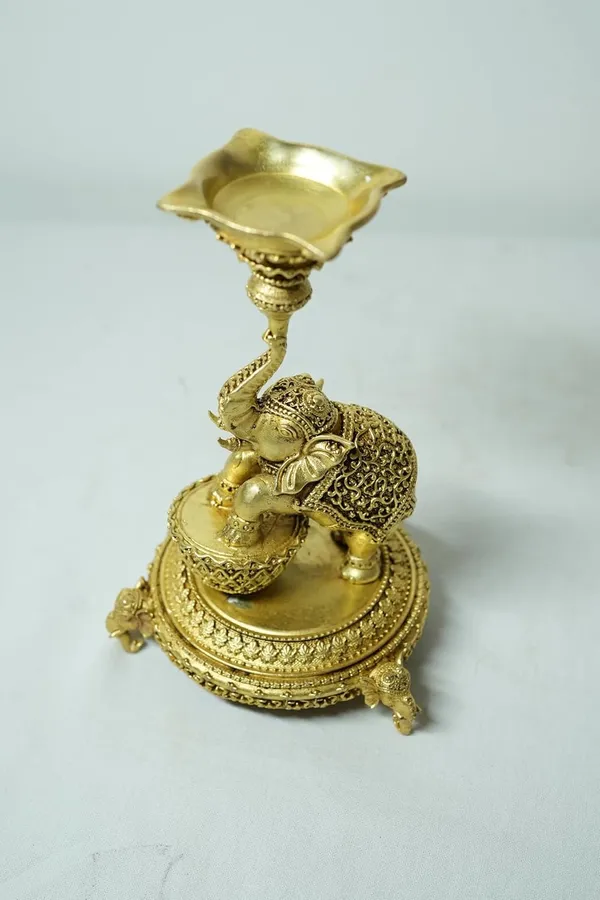Rahadecor_Golden_Brass_Elephant_Diya_Stand_with_Peacock_-_Traditional_Dancing_Elephant_Oil_Lamp_-_14cm_Height_Weight-320grams