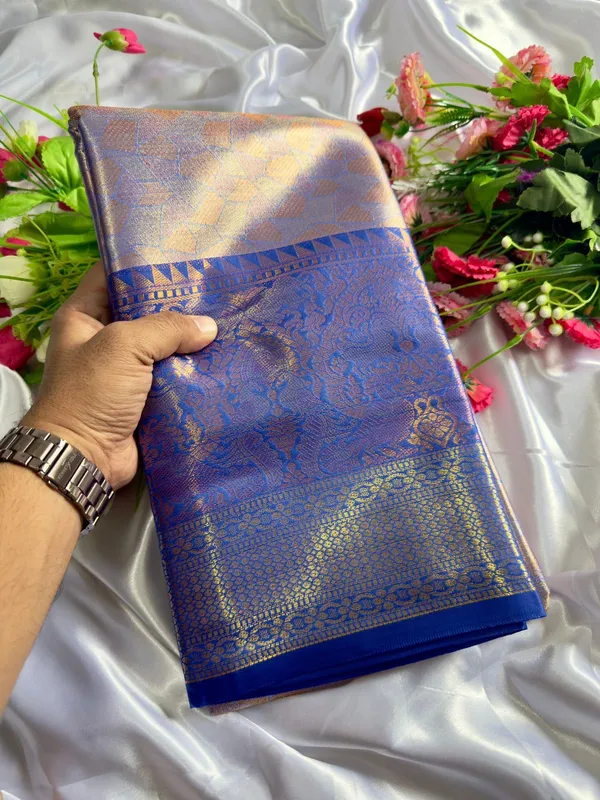Premium_Pattu_Tissue_Silk_Saree_crafted_with_a_rich_shimmering_finish_and_elegant_woven_texture,_designed_for_graceful_festive_and_wedding_wear._The_saree_features_a_luxurious_soft_drape_with_intricate_detailing_that_enhances_its_royal_appeal._Paired_with_a_matching_blouse_piece_for_a_complete_traditional_look.