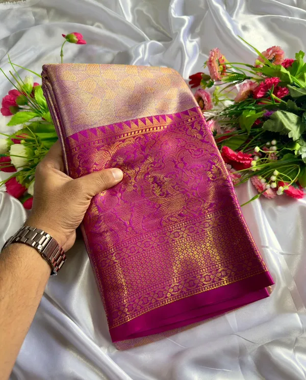 Premium_Pattu_Tissue_Silk_Saree_crafted_with_a_rich_shimmering_finish_and_elegant_woven_texture,_designed_for_graceful_festive_and_wedding_wear._The_saree_features_a_luxurious_soft_drape_with_intricate_detailing_that_enhances_its_royal_appeal._Paired_with_a_matching_blouse_piece_for_a_complete_traditional_look.