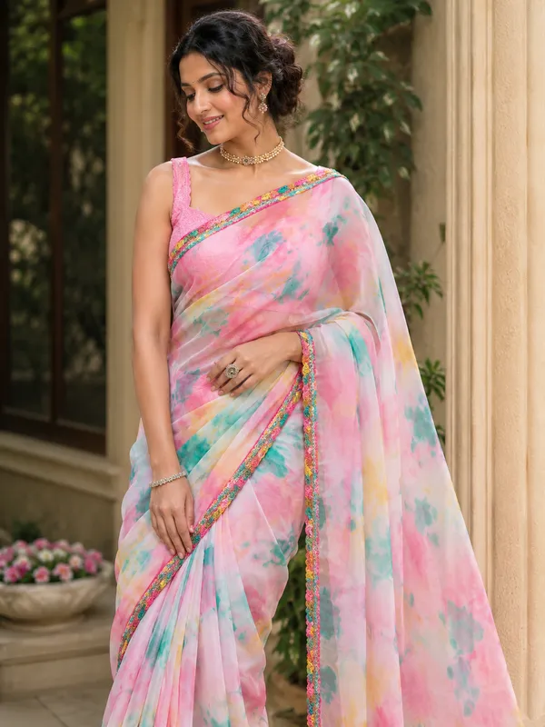 Stay_stylish_and_comfortable_all_day_with_this_beautiful_Georgette_Saree_featuring_an_elegant_multi-color_pattern_and_a_plain_contrast_pink_blouse_piece._Designed_with_a_graceful_lace_border,_this_saree_gives_a_soft,_lightweight_feel_that_makes_it_perfect_for_daily_wear,_office_wear,_casual_outings,_and_small_gatherings.