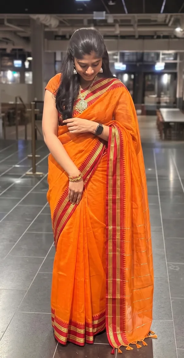 NRPT_Vibrant_Orange_Saree_with_Traditional_Red_Temple_Zari_Border