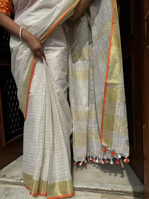 The_Onam_Aurora:_Off-White_Zari_Linen_Saree_with_Sunset_Orange_Blouse