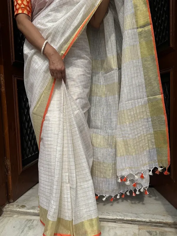 The_Onam_Aurora:_Off-White_Zari_Linen_Saree_with_Sunset_Orange_Blouse
