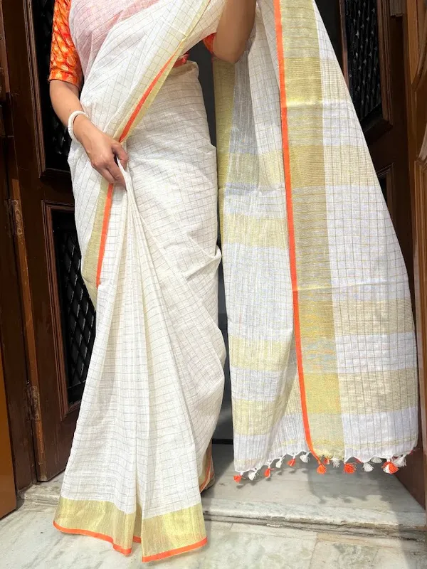 The_Onam_Aurora:_Off-White_Zari_Linen_Saree_with_Sunset_Orange_Blouse