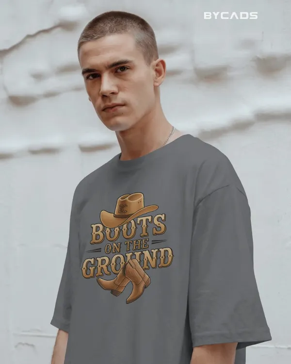 Grey_Cotton_Boots_On_The_Ground_Oversized_Unisex_T-Shirt_|_Western_Graphic_Tee