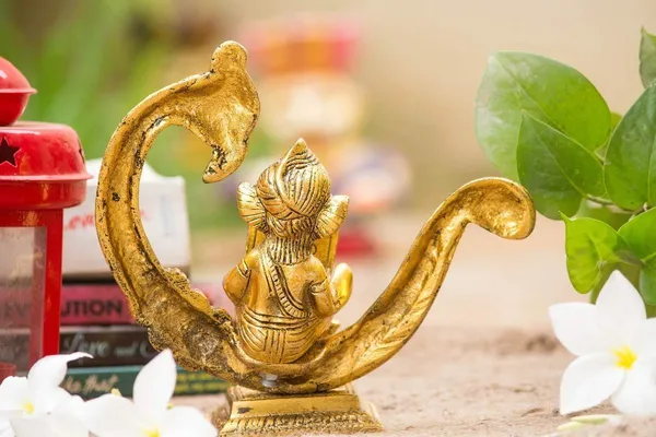 Reading_Ganesha_Idol_on_Peacock_Brass_Finish_Ganpati_Statue_with_Book_and_Om_Symbol_for_Home_Decor,_Office_Desk_&_Gift_6_Inch