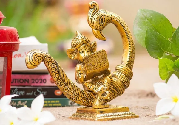 Reading_Ganesha_Idol_on_Peacock_Brass_Finish_Ganpati_Statue_with_Book_and_Om_Symbol_for_Home_Decor,_Office_Desk_&_Gift_6_Inch