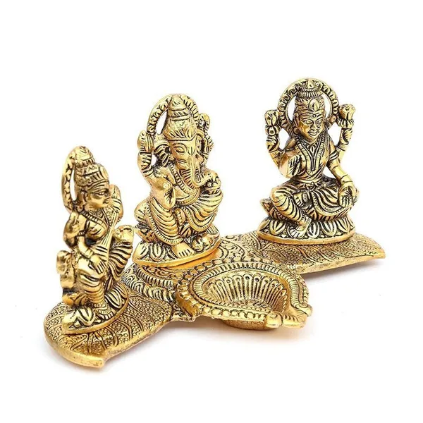 Brass_Lakshmi-Ganesha-Saraswati_Diya_Holder_on_Leaf_Plate_Gold-Tone_Hindu_Trio_Statues_with_Oil_Lamp_for_Gifting