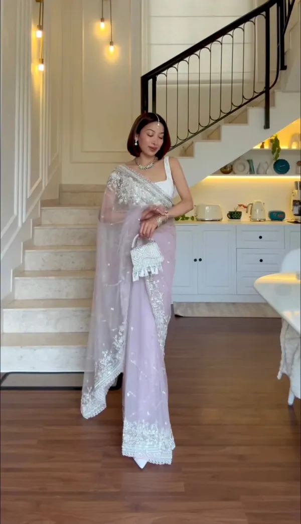 Lavender_Embroidered_Saree_With_Silver_Embellishments_And_White_Tassel_Clutch