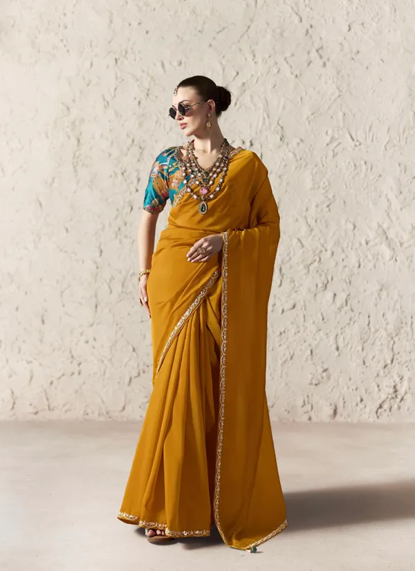 AN_EMBODIMENT_OF_UNDERSTATED_LUXURY,_THIS_SAREE_FEATURES_A_FLUID_DRAPE_AND_SOFT,_LUMINOUS_FINISH_,_ITS_ELEGANT_TEXTURE_AND_REFINED_CRFTSMANSHIP_CREATE_A_SILHOUETTE_THAT_IS_EFFORTLESSLY_GRACEFUL_PREFECT_FOR_BOTH_GRAND_OCCASIONS_AND_INTIMATE_CELEBRATION