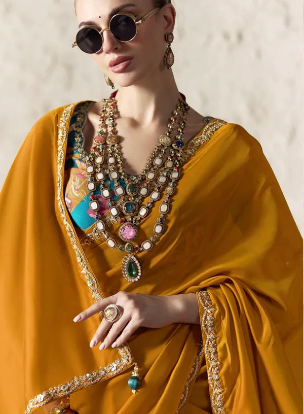 AN_EMBODIMENT_OF_UNDERSTATED_LUXURY,_THIS_SAREE_FEATURES_A_FLUID_DRAPE_AND_SOFT,_LUMINOUS_FINISH_,_ITS_ELEGANT_TEXTURE_AND_REFINED_CRFTSMANSHIP_CREATE_A_SILHOUETTE_THAT_IS_EFFORTLESSLY_GRACEFUL_PREFECT_FOR_BOTH_GRAND_OCCASIONS_AND_INTIMATE_CELEBRATION