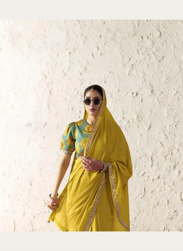 AN_EMBODIMENT_OF_UNDERSTATED_LUXURY,_THIS_SAREE_FEATURES_A_FLUID_DRAPE_AND_SOFT,_LUMINOUS_FINISH_,_ITS_ELEGANT_TEXTURE_AND_REFINED_CRFTSMANSHIP_CREATE_A_SILHOUETTE_THAT_IS_EFFORTLESSLY_GRACEFUL_PREFECT_FOR_BOTH_GRAND_OCCASIONS_AND_INTIMATE_CELEBRATION