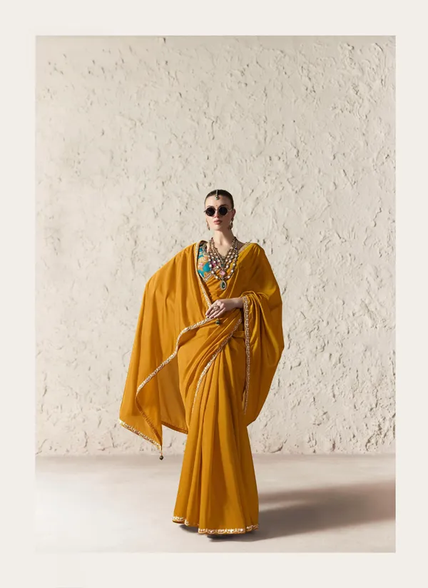 AN_EMBODIMENT_OF_UNDERSTATED_LUXURY,_THIS_SAREE_FEATURES_A_FLUID_DRAPE_AND_SOFT,_LUMINOUS_FINISH_,_ITS_ELEGANT_TEXTURE_AND_REFINED_CRFTSMANSHIP_CREATE_A_SILHOUETTE_THAT_IS_EFFORTLESSLY_GRACEFUL_PREFECT_FOR_BOTH_GRAND_OCCASIONS_AND_INTIMATE_CELEBRATION