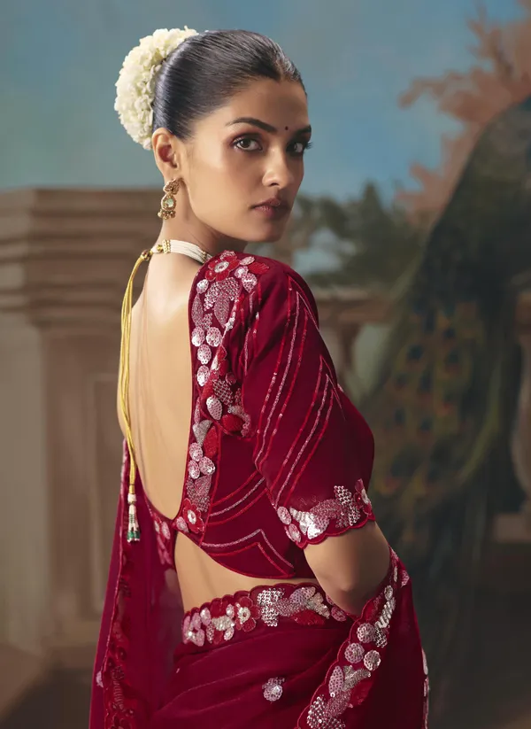 A_designer_work_saree_is_a_perfect_blend_of_tradition_and_contemporary_elegance._Crafted_with_intricate_embroidery,_shimmering_sequins,_delicate_zari,_and_fine_beadwork,_these_sarees_showcase_the_artistry_and_craftsmanship_of_skilled_designers.