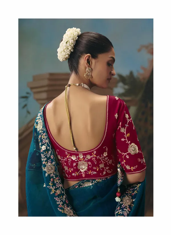 A_designer_work_saree_is_a_perfect_blend_of_tradition_and_contemporary_elegance._Crafted_with_intricate_embroidery,_shimmering_sequins,_delicate_zari,_and_fine_beadwork,_these_sarees_showcase_the_artistry_and_craftsmanship_of_skilled_designers.