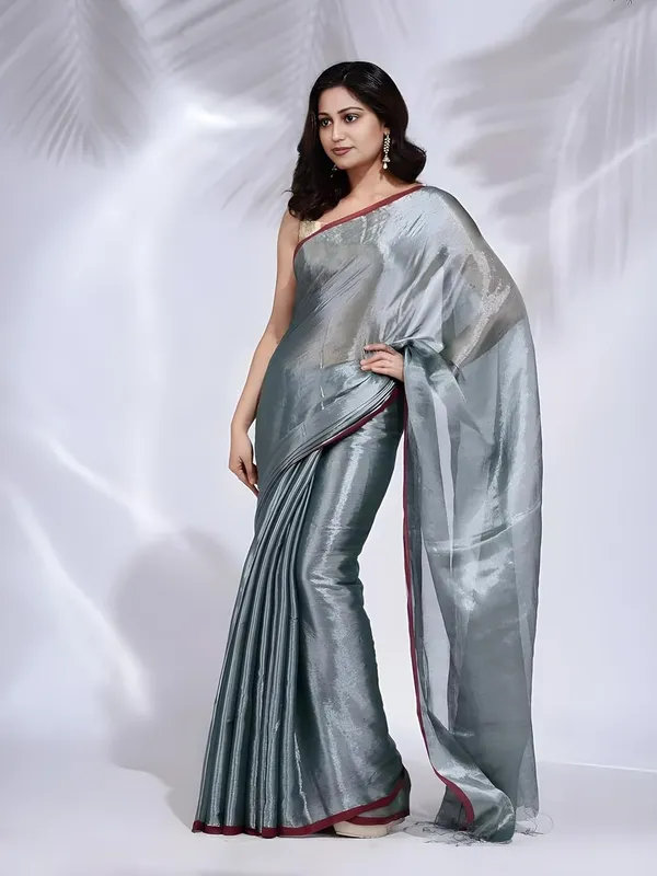 Grey_Handloom_Glossy_Tissue_Saree_With_Rich_Red_Border_Soft,_Lightweight_&_Lustrous_Finish_Perfect_For_Weddings,_Traditional_Elegance_Artisanal_Weaving_Masterpiece_For_Women