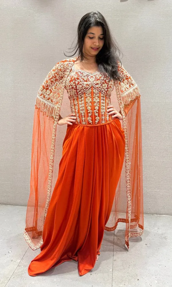 Orange_Premium_Roman_Silk_Western_Dhoti_Set_With_Net_Shrug_For_Women
