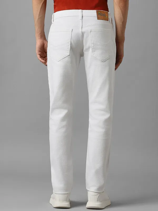 White_Cotton_Blend_Slim_Mid_Rise_Jeans_For_Men