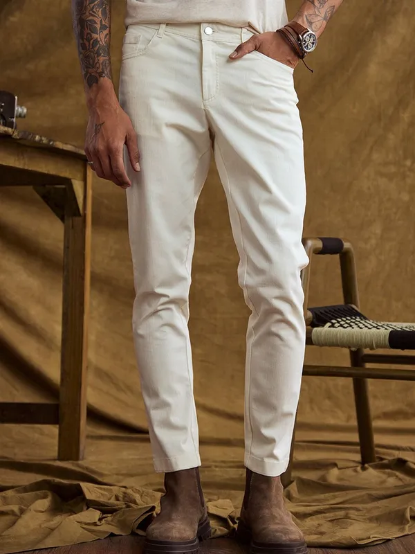 White_Cotton_Blend_Slim_Mid_Rise_Jeans_For_Men