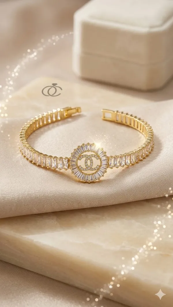 Shubh_aura_presents_A_gold_plated_bracelet,_its_design_made_with_CC_monogram_topped_with_a_small_diamond_stone,_Its_crafted_with_2_C_interlock_with_bold_and_iconic_statement_,_Its_Sparkle_and_polished_finish_add_timelss_beauty