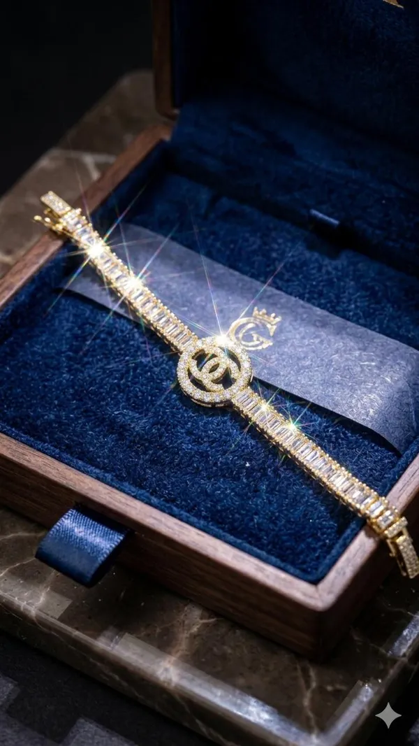 Shubh_aura_presents_A_gold_plated_bracelet,_its_design_made_with_CC_monogram_topped_with_a_small_diamond_stone,_Its_crafted_with_2_C_interlock_with_bold_and_iconic_statement_,_Its_Sparkle_and_polished_finish_add_timelss_beauty