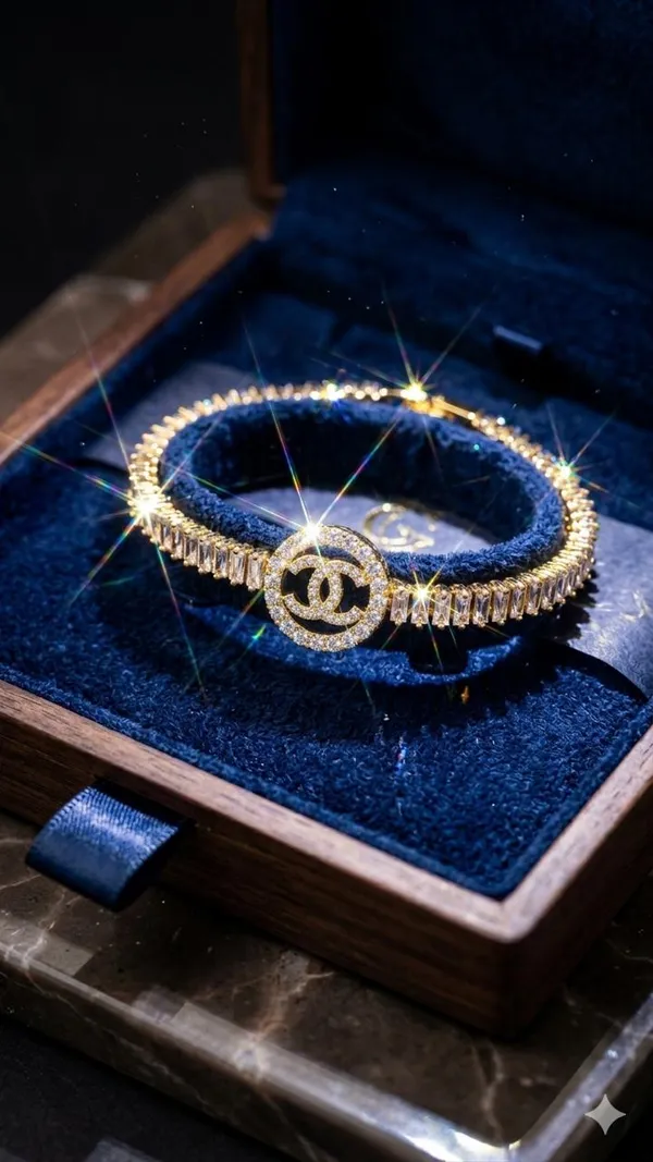 Shubh_aura_presents_A_gold_plated_bracelet,_its_design_made_with_CC_monogram_topped_with_a_small_diamond_stone,_Its_crafted_with_2_C_interlock_with_bold_and_iconic_statement_,_Its_Sparkle_and_polished_finish_add_timelss_beauty