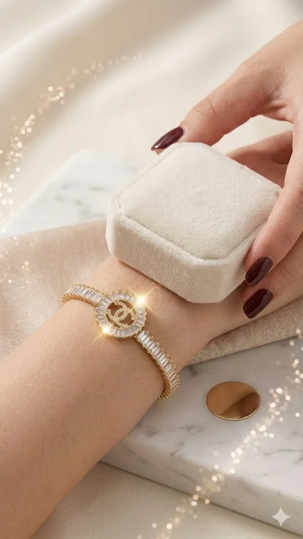 Shubh_aura_presents_A_gold_plated_bracelet,_its_design_made_with_CC_monogram_topped_with_a_small_diamond_stone,_Its_crafted_with_2_C_interlock_with_bold_and_iconic_statement_,_Its_Sparkle_and_polished_finish_add_timelss_beauty