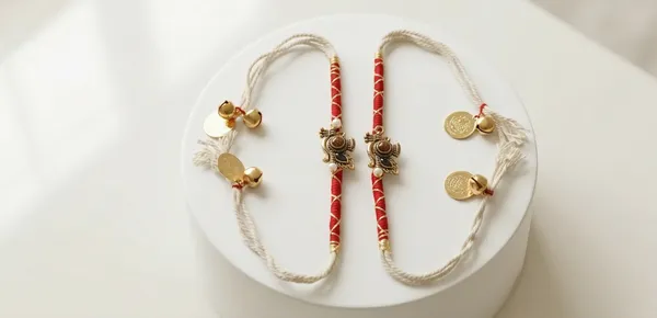 Krishna_Feather_&_Bansuri_Rakhi_Pair_with_Rudraksha_Beads_–_Premium_Spiritual_Rakhi_Set