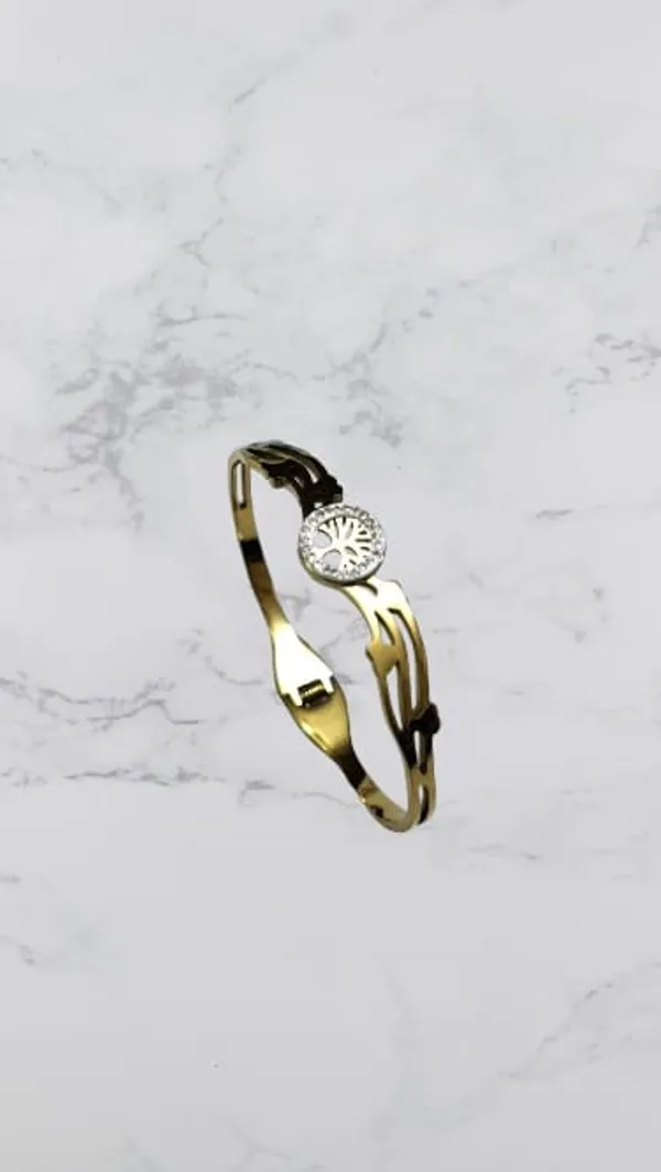 Gold_Toned_Sleek,_Curved_Metal_With_A_Central_Sparkling_Floral_Like_Design