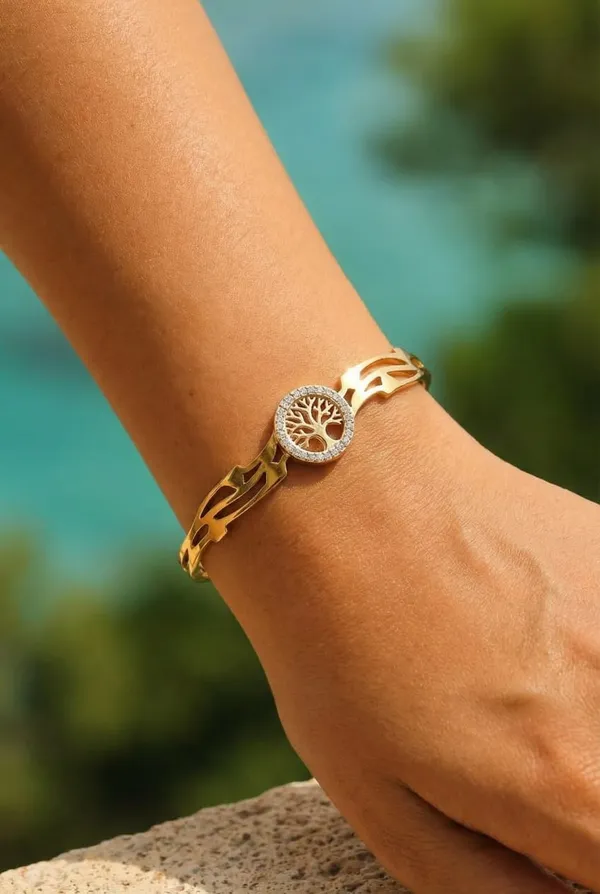 Gold_Toned_Sleek,_Curved_Metal_With_A_Central_Sparkling_Floral_Like_Design