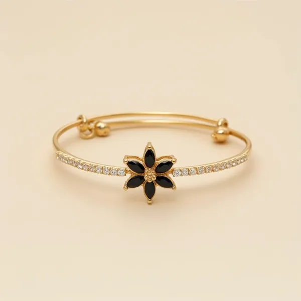 Gold_Toned_Bracelet_With_Central_Star_Shaped_Motiff_Of_Black_Gemstones_In_Floral_Setting
