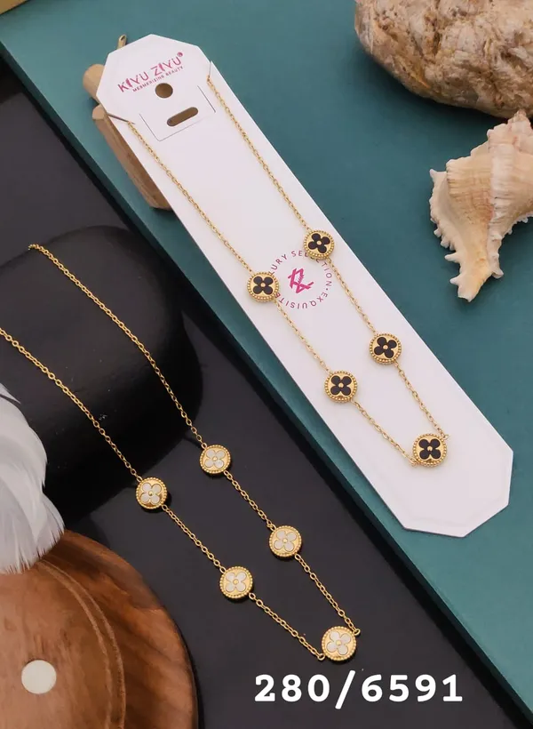 Elegant_Golden_Clover_Necklace_with_Black_&_White_Stone_Accents