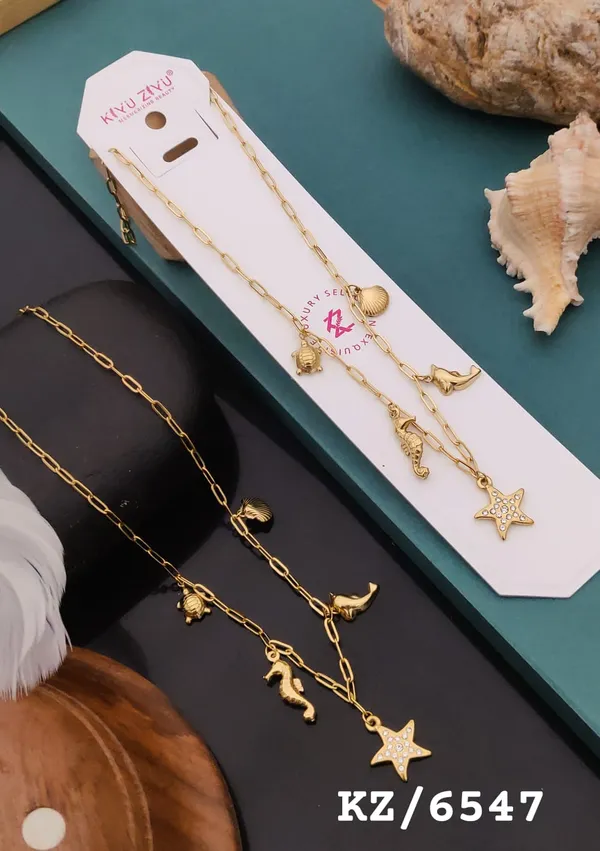 Gold-Tone_Seashell_Charm_Necklace_With_Star_And_Marine_Life_Pendants