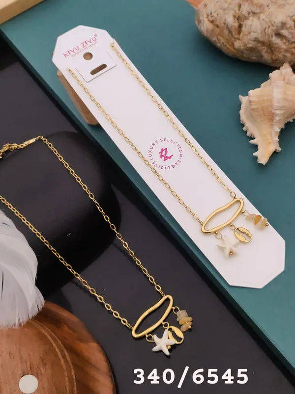 Gold-Tone_Pendant_Necklace_With_Star_And_Shell_Charms