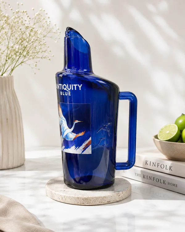 Upcycled_Glass_Jug_with_Signature_Name_&_Logo_Sticker_–_700_ML_|_8.5_Inch_|_Made_from_Antiquity_Blue®_Bottles