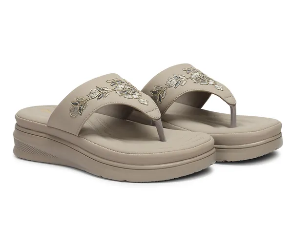A_pair_of_stylish_women�s_slip-on_loafers_in_a_warm_tan/brown_color_with_a_subtle_ribbed_texture.