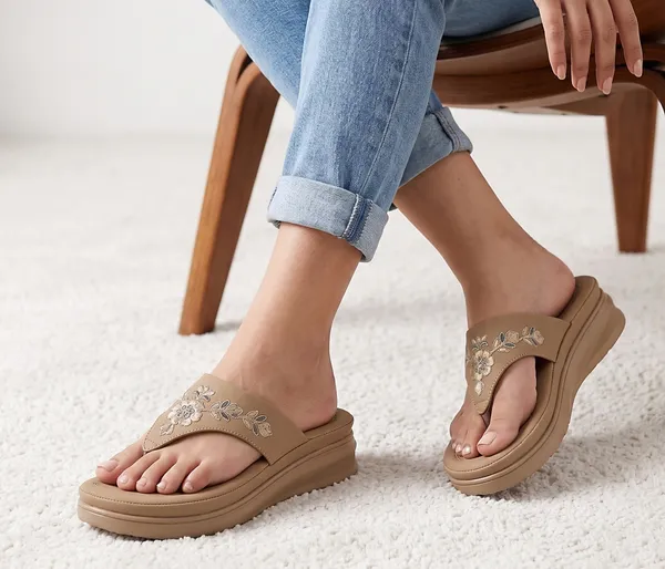 A_pair_of_stylish_women�s_slip-on_loafers_in_a_warm_tan/brown_color_with_a_subtle_ribbed_texture.