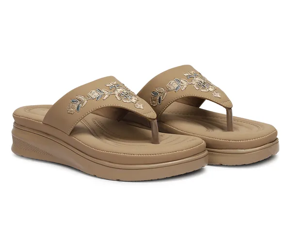 A_pair_of_stylish_women�s_slip-on_loafers_in_a_warm_tan/brown_color_with_a_subtle_ribbed_texture.