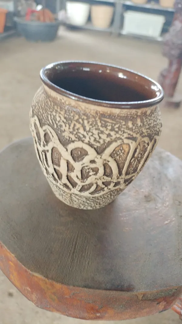Handcrafted_Ceramic_Cup_With_Textured_Floral_Design