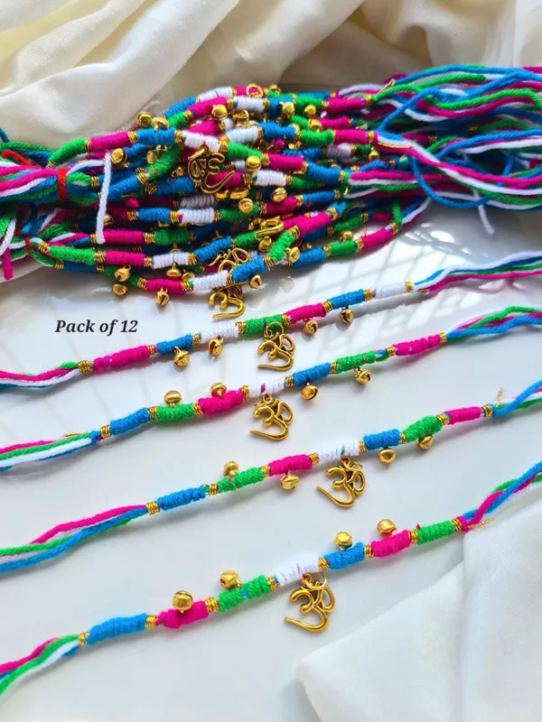 Auspicious_Om_Charm_Rakhi_Multicolor_Cotton_Thread_Designer_Spiritual_Rakhi_with_Golden_Bells_for_Brother_Raksha_Bandhan_Gift