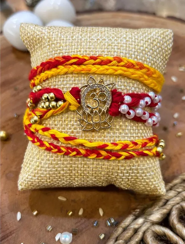 Handmade_Divine_Om_Lotus_Rakhi_with_Sacred_Om_Charm_Red_Yellow_Braided_Thread_Raksha_Bandhan_Premium_Collection
